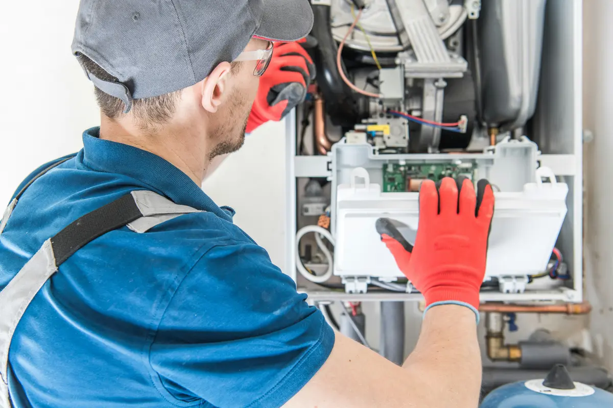 HVAC technician performing annual maintenance on a boiler in Montreal