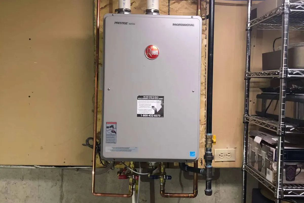 Rheem tankless water heater installed on a wall in a Montreal basement