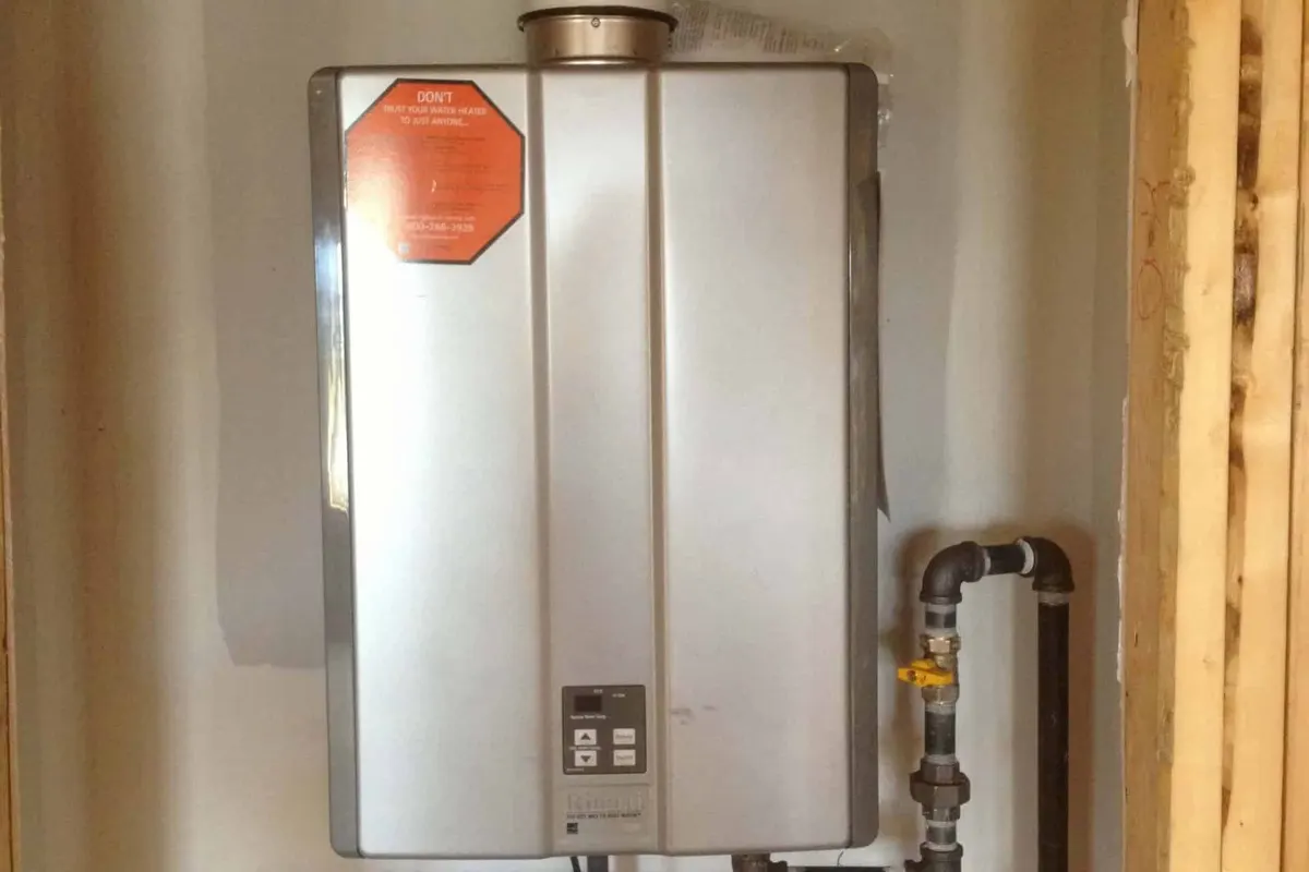Wall-mounted tankless unit service in progress