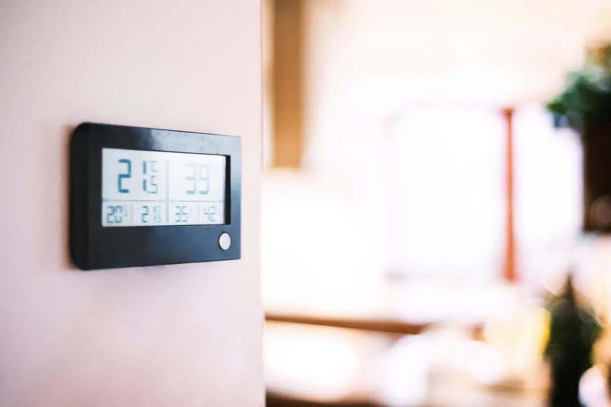 Modern smart thermostat on a residential wall in Montreal